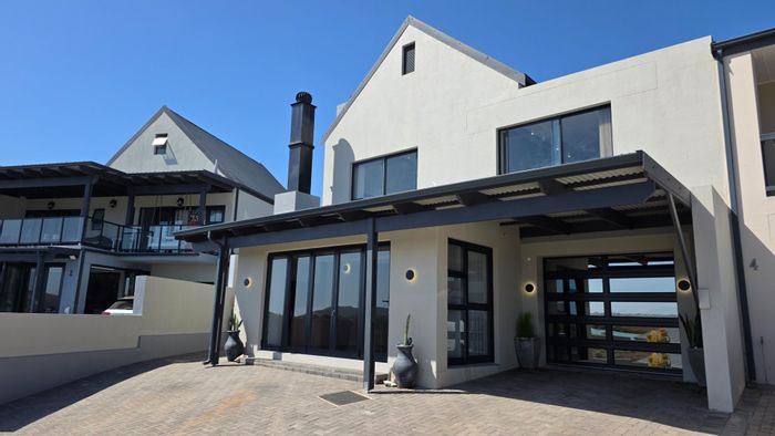 For Sale: Hartenbos Central townhouse with braai area, garage, and river views.