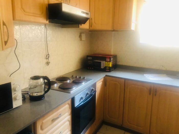 Durban Central Apartment To Rent: Student accommodation with beds, kitchen, and free Wi-Fi.