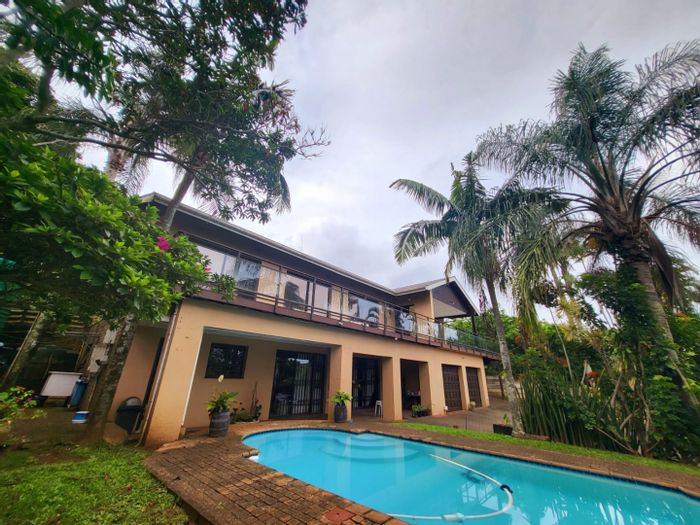 Ocean-view Uvongo house with dual flats, pool, and expansive entertainment space for sale.