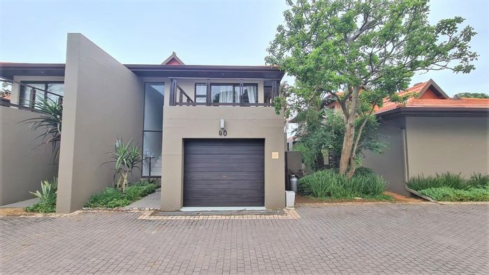 Zimbali Townhouse For Sale: Open plan living, garage, communal pool, forest views.