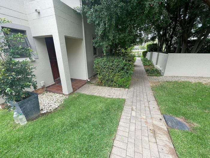 For Sale: Apartment in Bryanston with private garden, covered patio, and carport.