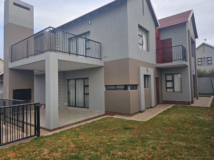 For Sale: Townhouse in Wild Olive Estate with pool, balconies, and double garages.