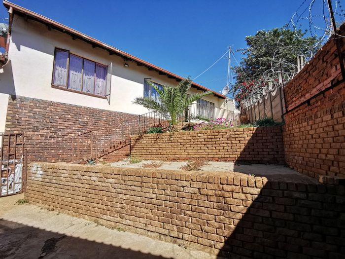 Laudium House For Sale: Spacious layout, outbuildings, double carport, gated security.