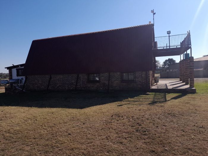 Koppies Central House For Sale: Two homes, granny cottage, boreholes, and farming land.