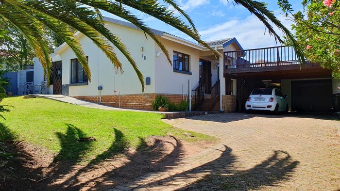 Spacious Dana Bay house for sale with large garden, built-in braai, and ocean views.