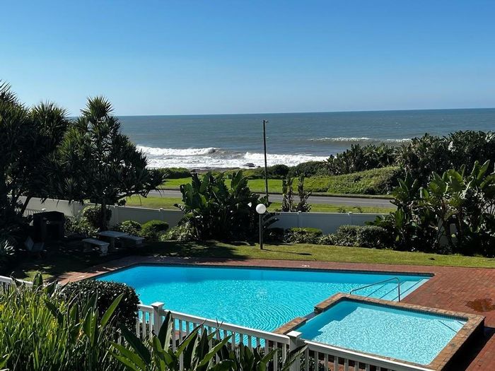 Beachfront apartment in Uvongo for sale, with pools, tennis court, and sea views.