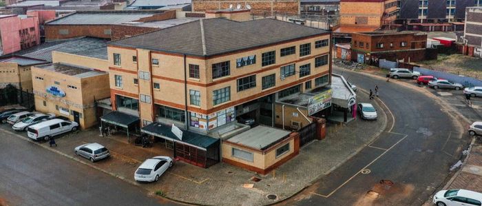 Commercial property for sale in Lenasia Ext 1 with shops, apartments, and elevator.