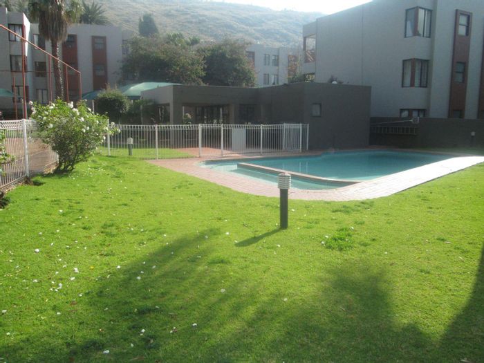 Garden apartment in Morning Hill with pool, tennis court, and 24-hour security.