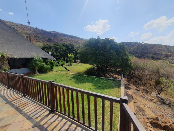 Versatile house in Hartbeespoort Rural with bar, gardens, and multiple amenities. To Rent.