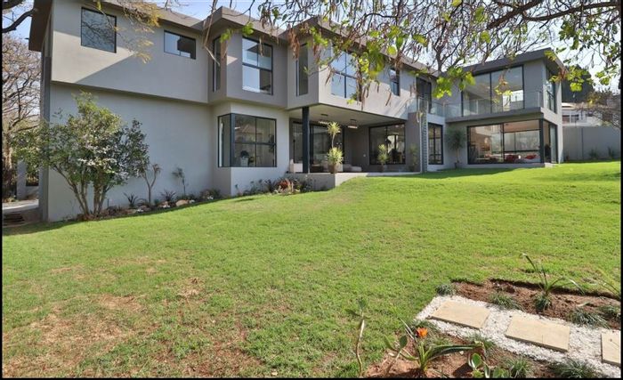 For Sale: Spacious Bryanston house with garden, garages, study, and energy-efficient features.