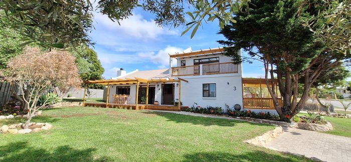 For Sale: Spacious 4-bedroom house in Stilbaai Wes with views, garage, and garden.