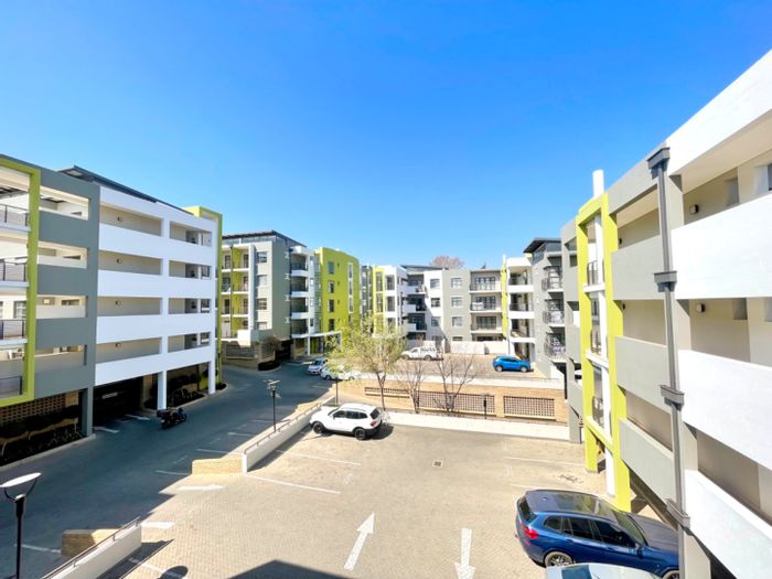 Rivonia Apartment For Sale: Spacious 1-bedroom, open plan living, balcony, and kitchen.