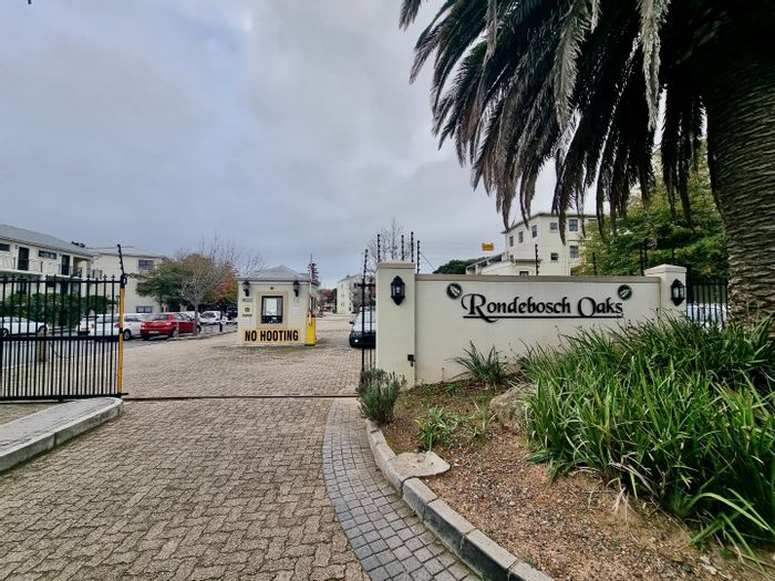 For Sale: Apartment in Rondebosch Village with tenant, parking, and garden views.