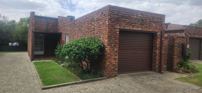 For Sale: 3-Bedroom Townhouse in Standerton Central with secure parking and outdoor space.