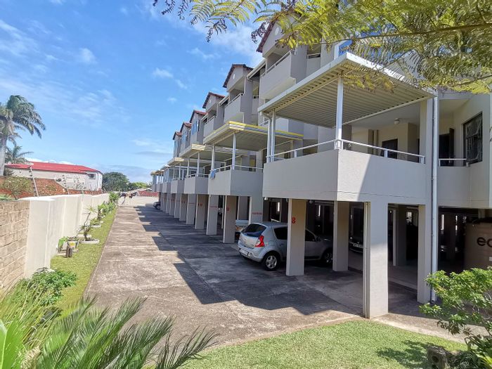 Uvongo Beach Apartment For Sale: Steps to beach, parking, and sea view balcony.