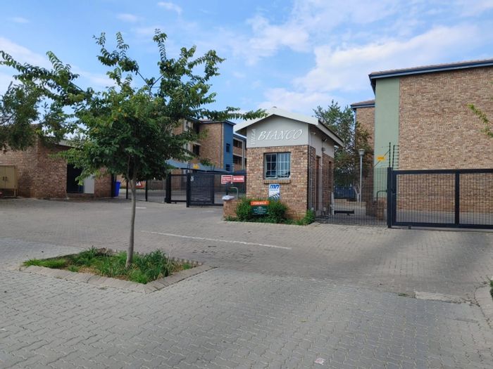 For Sale: Apartment in Rooihuiskraal North with security, pool, and parking.
