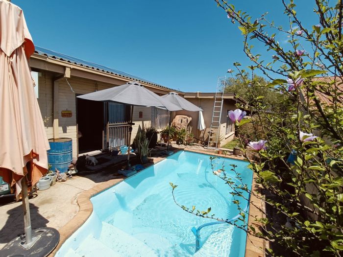 Family home in Uitsig for sale, features pool, solar power, and ample parking.