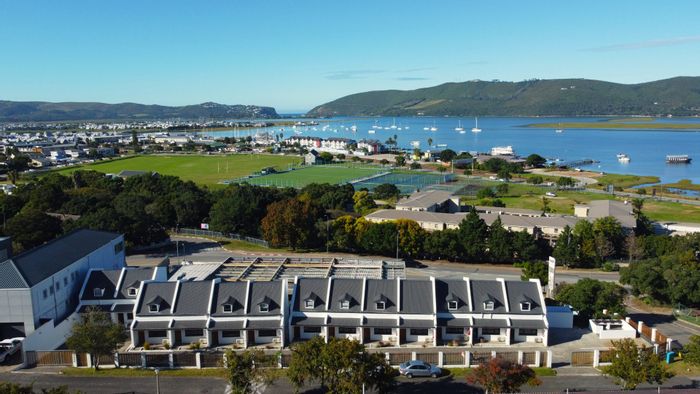 Westhill Apartment For Sale: Open-plan living, balcony views, communal braai area.