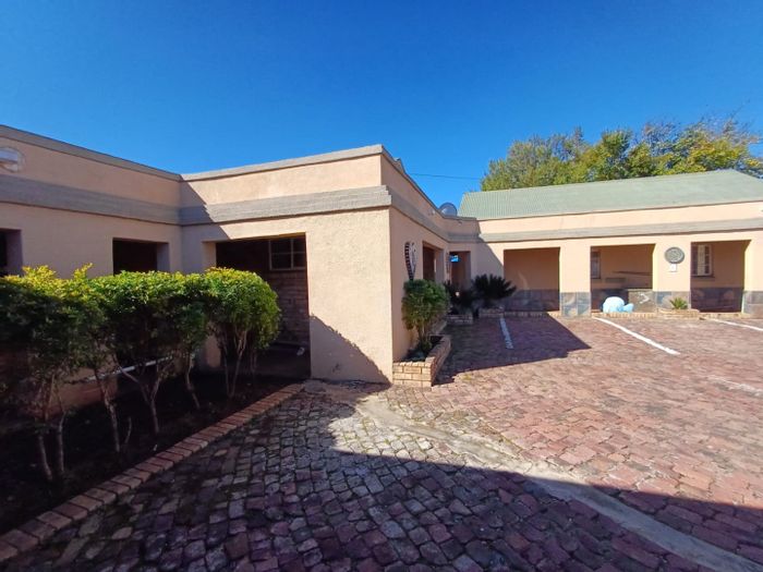 Commercial Guesthouse For Sale in Wilkoppies: 6 flats, 10 rooms, pool, and security.