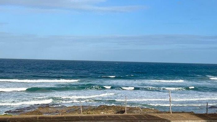 Beachfront apartment in Uvongo for sale, with pool, direct beach access, and parking.