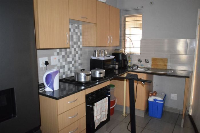 Klippoortjie Townhouse For Sale: 1-bedroom, pool, open-plan living, secure parking.