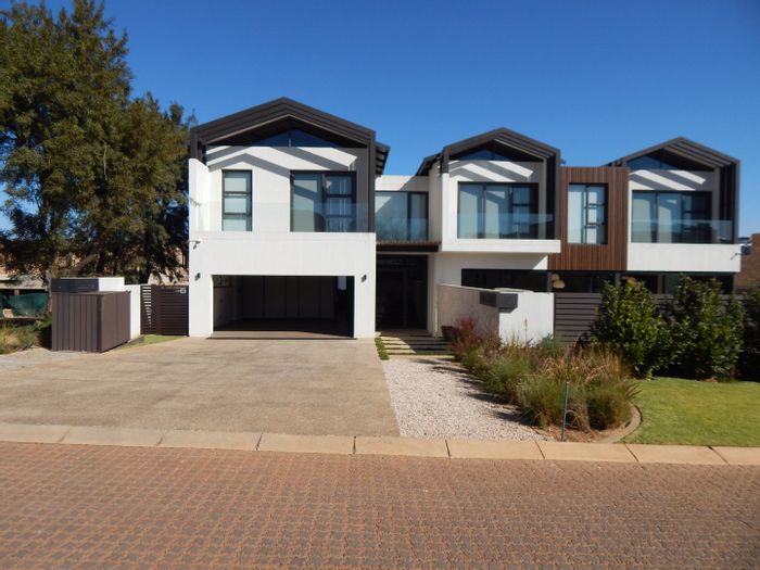 4-Bedroom House To Rent in Helderfontein Estate with pool, garden, and security.