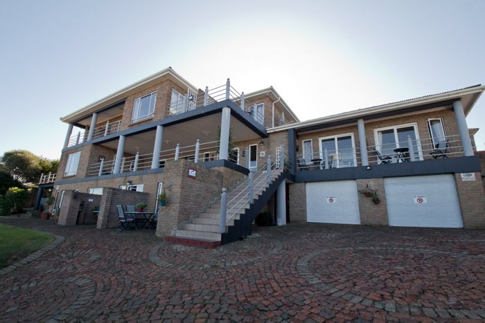 For Sale: House in Dana Bay with 11 guest units, pool, and sea views.