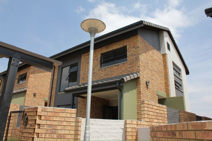 For Sale: Apartment in Rooihuiskraal North with pool, security, and parking.