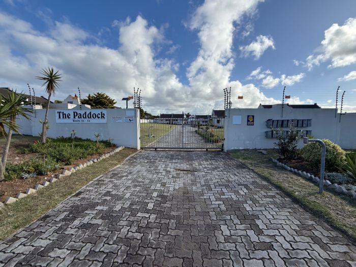 For Sale: Spacious 2-bed townhouse in Lorraine with private garden and carport.