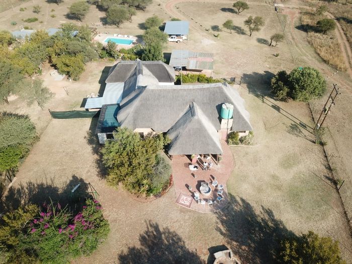 Farm For Sale in Dinokeng Game Reserve: Lodge, guest cottage, and ample amenities.