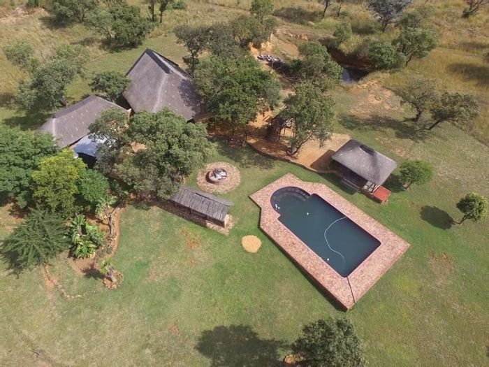 21-hectare farm in Dinokeng Game Reserve with lodge, Lapa, and guest chalets for sale.