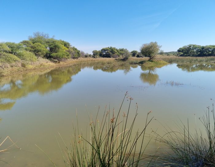 Farm for Sale in Swartruggens Central: Water rights, game fencing, boreholes, and ample space.