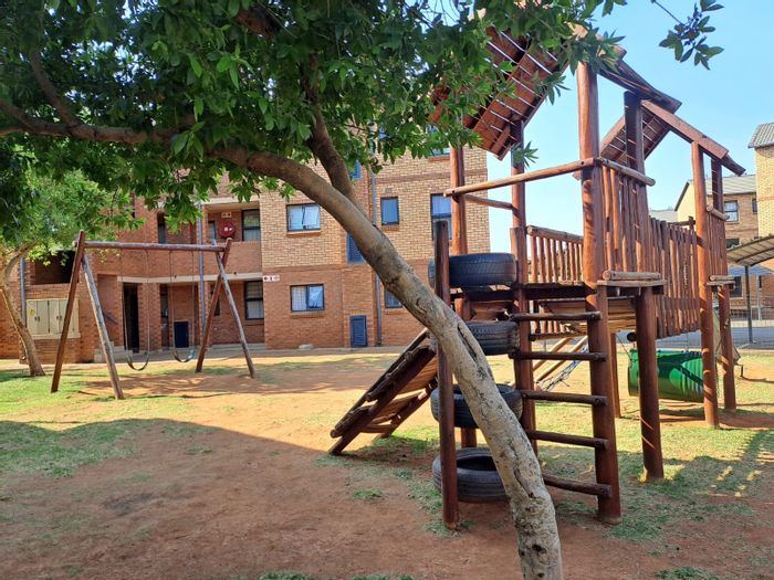 For Sale: Ground floor apartment in Olympus AH with patio, carport, and kids' play area.