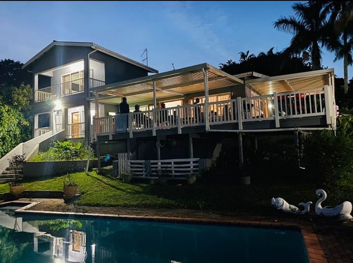 Beachfront house in Pumula for sale, features pool, patio, and ocean access.