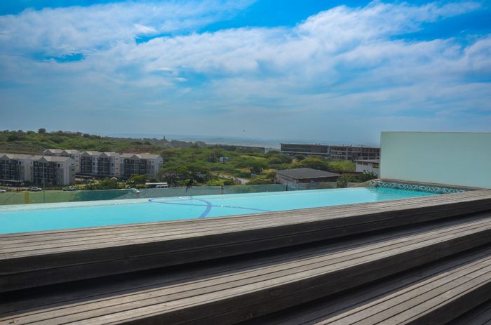 Ballito Central Apartment To Rent: 2 beds, rooftop pool, 24-hour security, prime location.