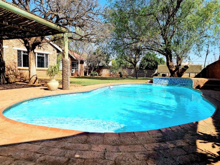 For Sale: Spacious Rhodesdene house with flat, pool, garden, and ample parking.