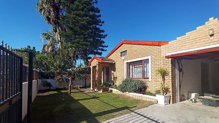 For Sale: Ottery House with 3 beds, flatlet, 4 garages, and patio.