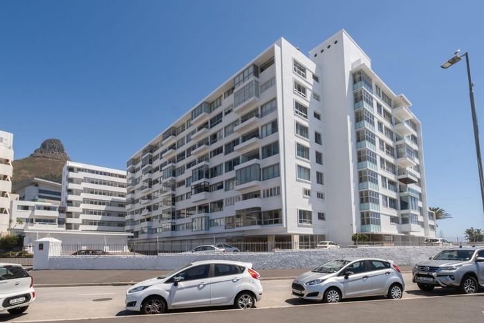 Sea Point Apartment To Rent: Secure building, ocean views, enclosed balcony, fiber-ready.