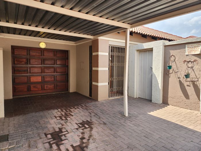 Townhouse To Rent in Secunda Central: Garage, pet-friendly yard, enclosed patio, storage.