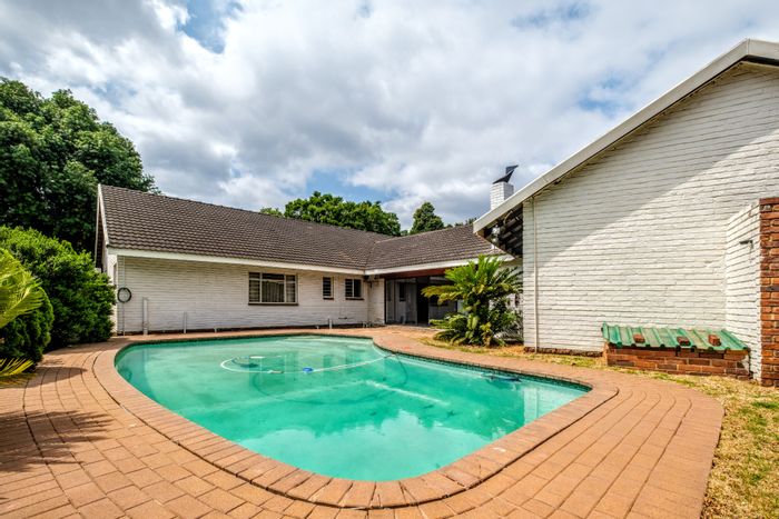 Spacious 5-bedroom house in Waterkloof Ridge with pool, braai room, and security.