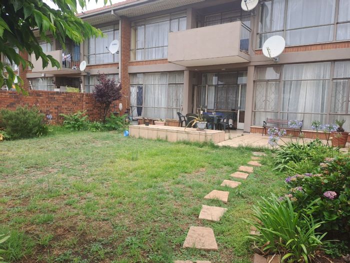 For Sale: Benoni Central Apartment with 2 bedrooms, garden, and open-plan living.