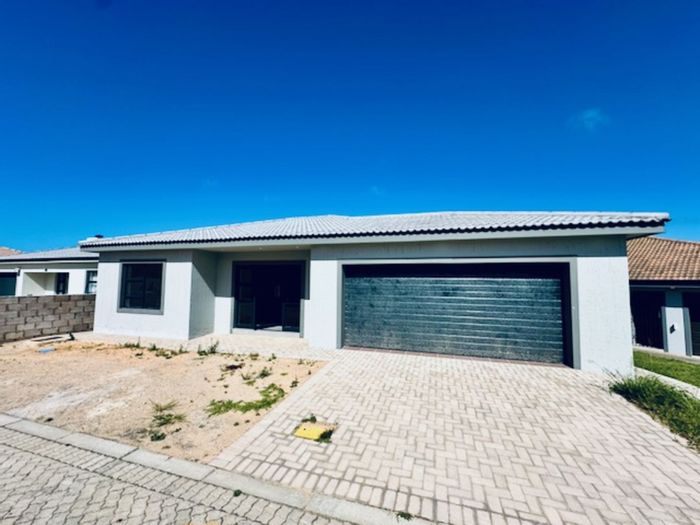 For Sale: House in Dana Bay with open-plan living, double garage, and braai area.