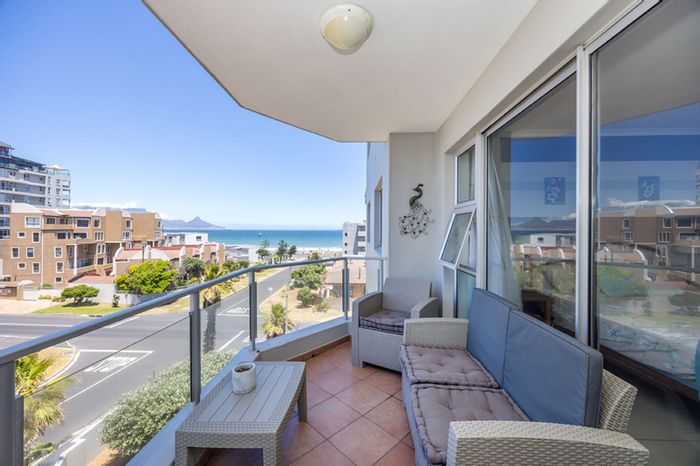 Bloubergstrand Apartment For Sale: 2 bedrooms, balcony views, secure parking, communal laundry.