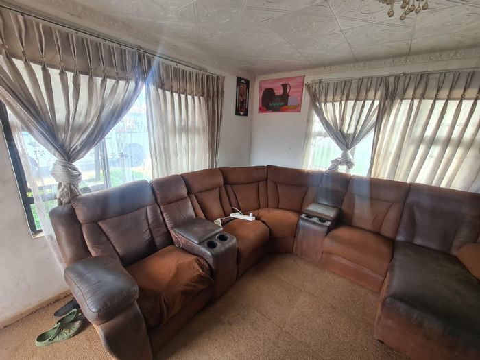 For Sale: Family home in Roodepan with garden, secure parking, and three bedrooms.