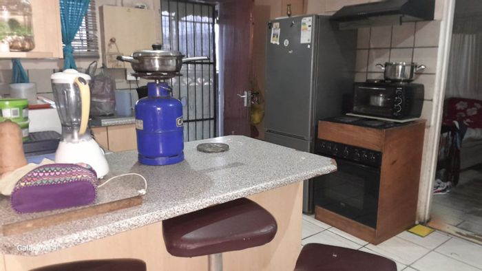 For Sale: Two-bedroom house in Groenheuwel with paved outdoor space and security features.