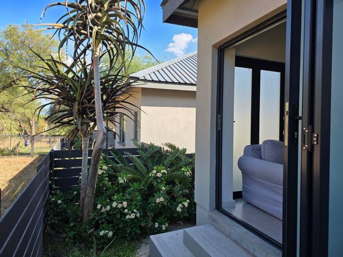 For Sale: House in Hoedspruit Central with 2 beds, secure parking, and bush views.