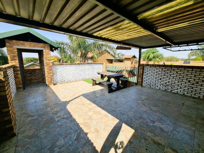Top-floor 2-bedroom apartment in Highveld with private patio and secure garage. For Sale.