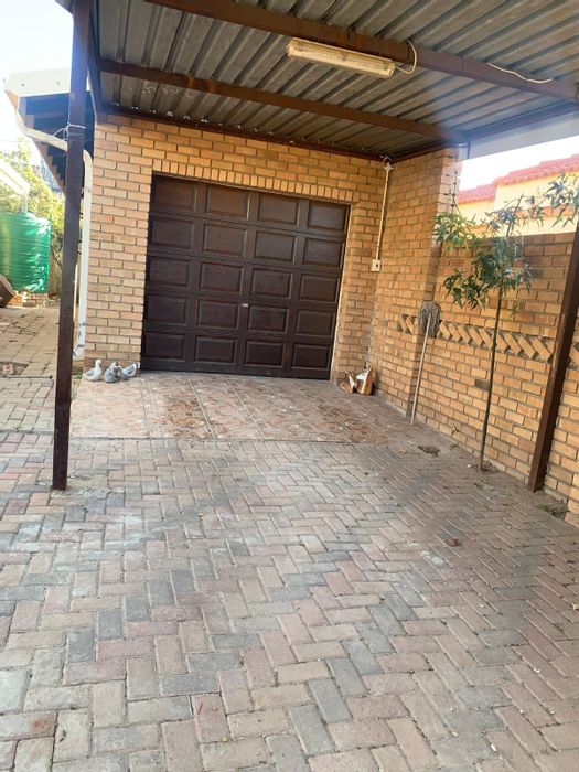 African Jewel House For Sale: 3 beds, spacious yard, garage, close to amenities.