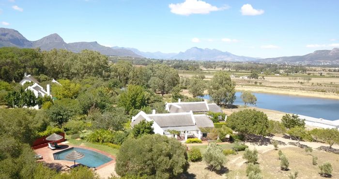 For Sale: Paarl Rural Farm with vineyards, equestrian facilities, and guest cottages.