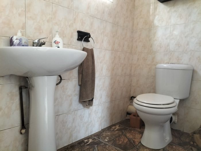 Spacious 4-bedroom house with pool, double garages, and staff quarters in Stilfontein Ext 4. For Sale.